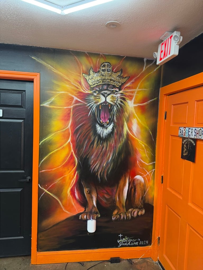 Mural of a roaring crowned lion with orange and yellow flames on black wall between orange doors in a barber shop