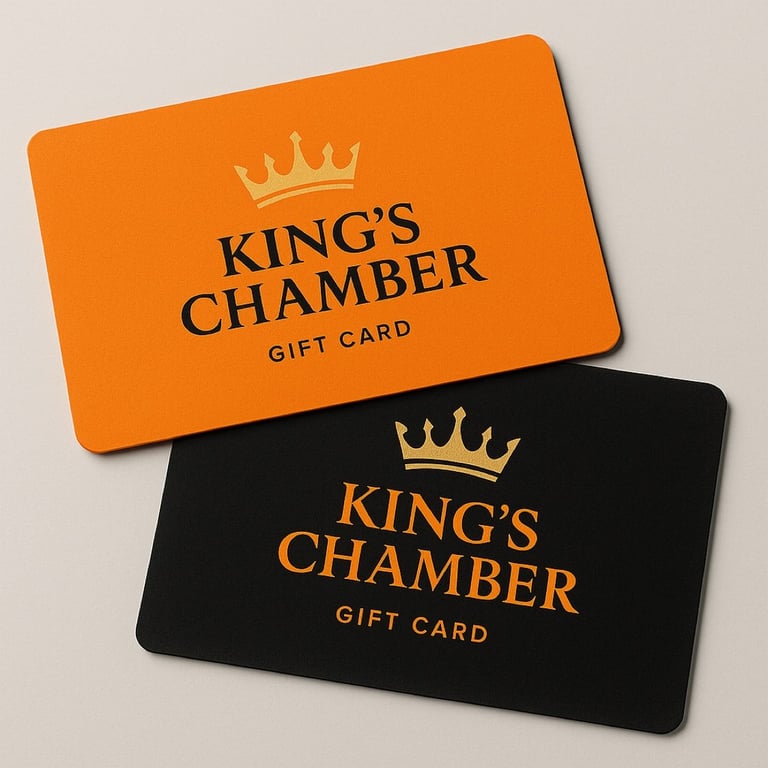 Two Kings Chamber gift cards, one orange and one black, featuring a crown logo and brand text